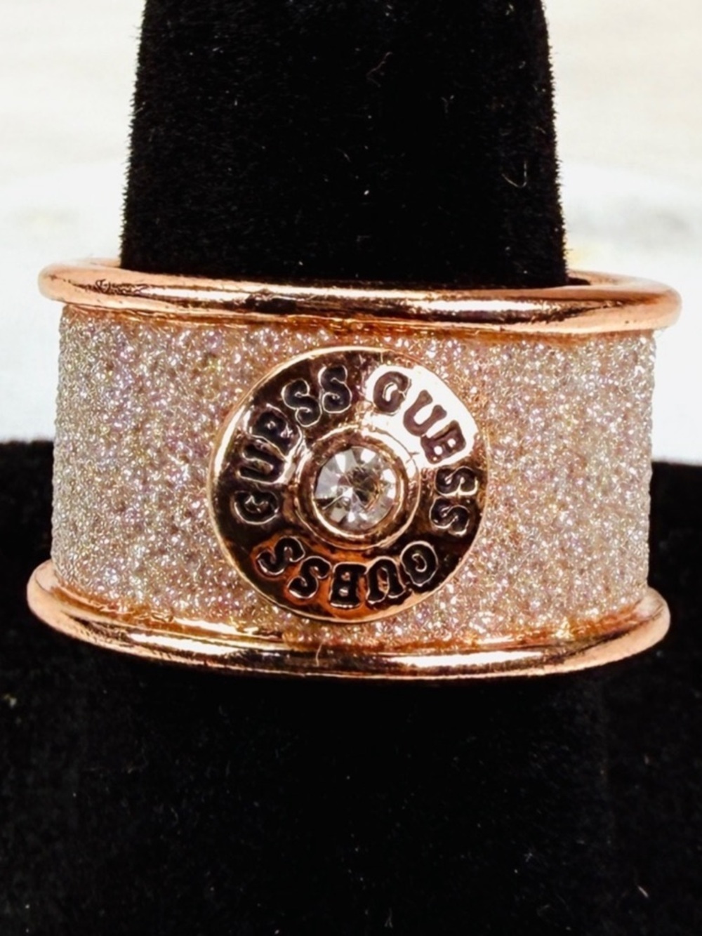 Beautiful frosted rose goldtone, wide band, 6 1/2 Guess costume ring